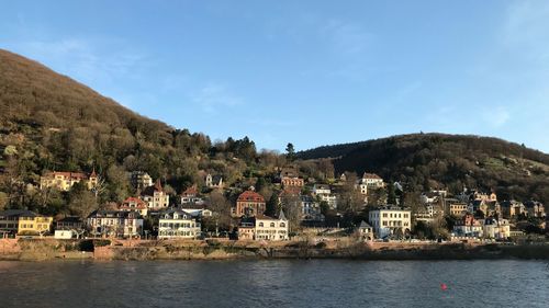 Townscape by sea against sky