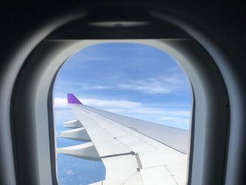 View of cloudy sky seen through airplane window