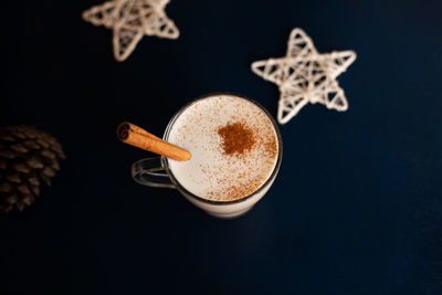 Homemade traditional christmas drink eggnog with spices and cinnamon. winter holidays