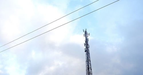 Low angle view of communications tower against sky