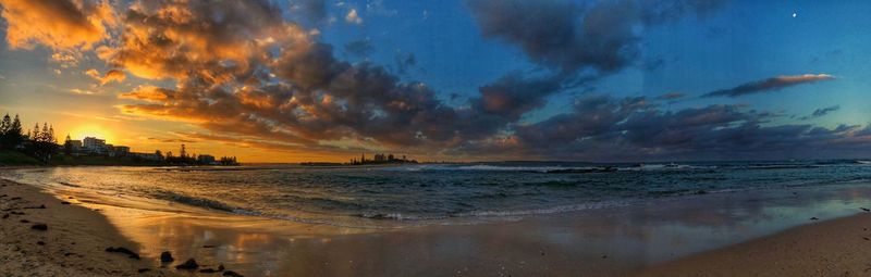 Panoramic view of beach against sky during sunset