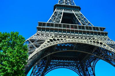 Low angle view of eiffel tower against clear blue sky