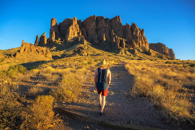 Rear view of man standing on rock