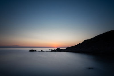 Scenic view of sea against clear sky during sunset - long exposure