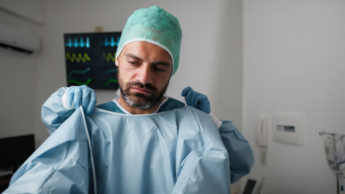 Portrait of young man wearing surgical mask