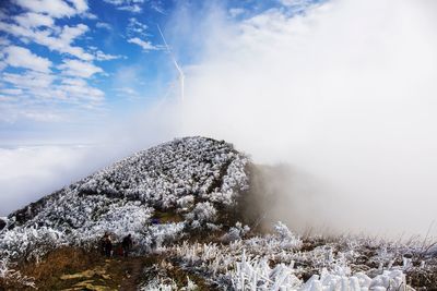 Scenic view of mountain against sky during foggy weather