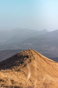 Scenic view of arid landscape against sky