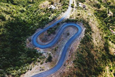 High angle view of winding road amidst trees