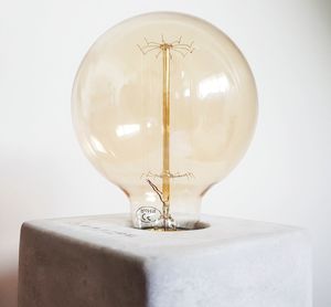 Close-up of light bulb against white background