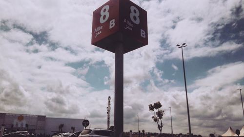 Low angle view of road sign against sky