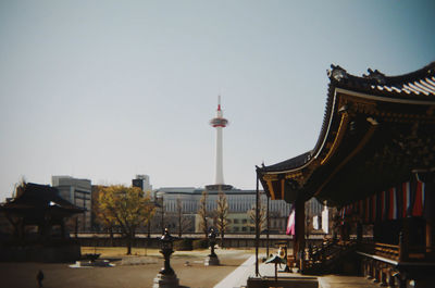 Buildings in city against clear sky