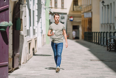 Portrait of young woman walking on street