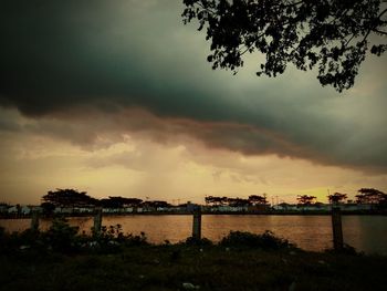 Scenic view of river against sky at sunset