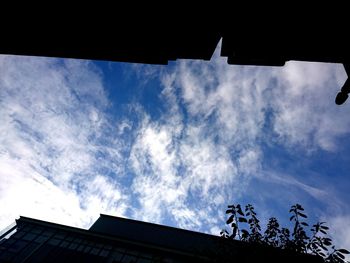 Low angle view of building against cloudy sky