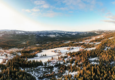 Aerial view of snowcapped landscape against sky