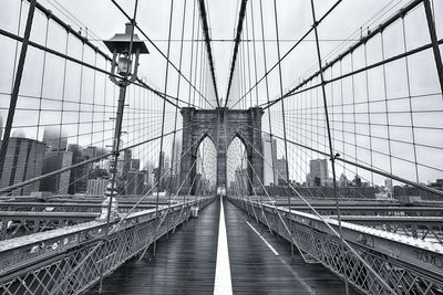 Brooklyn bridge in city against sky