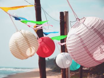 Low angle view of lanterns hanging against sky