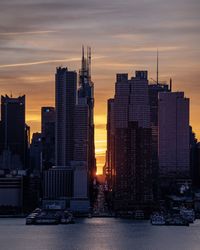 Modern buildings against sky during sunset