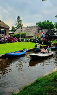 Boats in lake against buildings