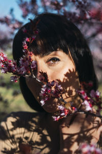 Portrait of woman with pink flowers