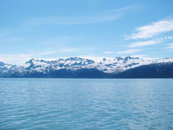 Scenic view of lake and snowcapped mountains against sky