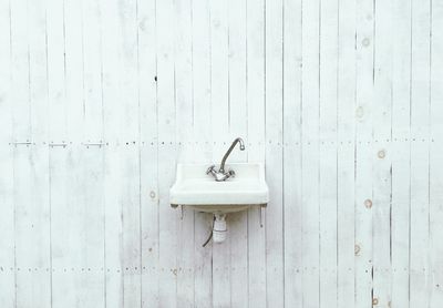 Sink on wooden wall