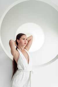 Portrait of young woman standing in tunnel