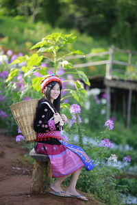 Portrait of woman on purple flowering plant