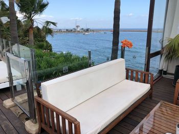 View of swimming pool by sea against sky