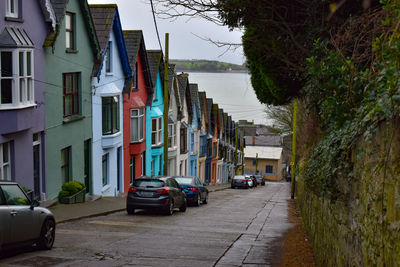 Cars on street amidst buildings in city