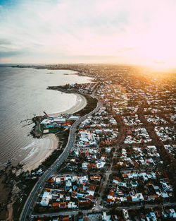 High angle view of road by sea against sky during sunset