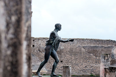 Side view of statue against sky