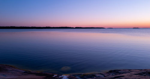 Scenic view of sea against clear sky during sunset