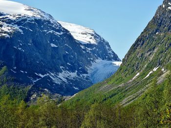 Scenic view of mountains against clear blue sky