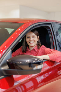 Portrait of young woman in car