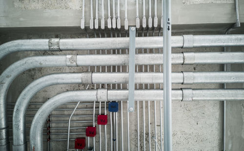 Close-up of pipes on railing against building