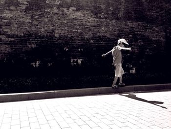Full length of young woman jumping