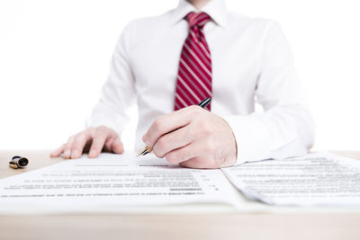 Midsection of man with umbrella on table