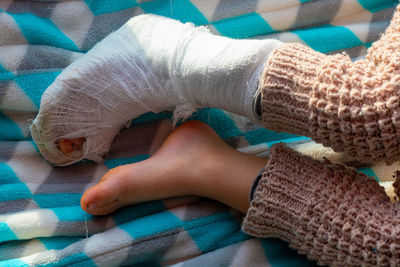 Child with bandage on leg heel fracture. broken right foot, splint of toddler. 