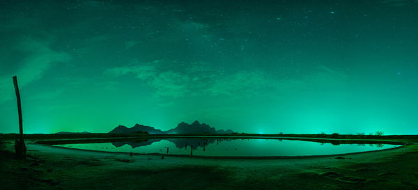 Scenic view of lake against sky at night