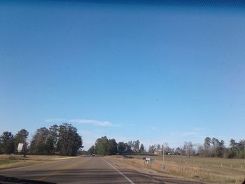 Road against clear blue sky