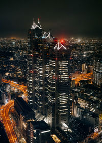 High angle view of illuminated buildings in city at night