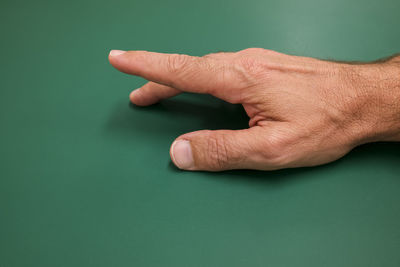 Close-up of human hand against gray background