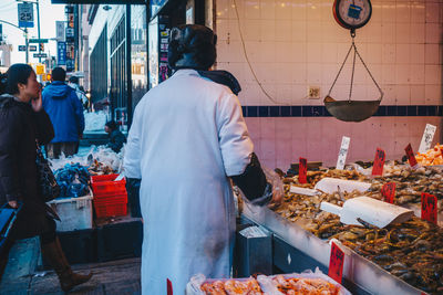 People working at market stall