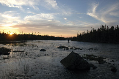 Scenic view of river at sunset