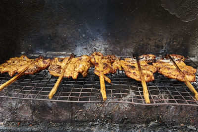 Grilled chickens on metal grate