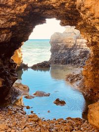 Scenic view of sea seen through cave