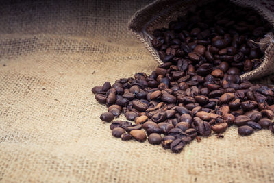 Close-up of roasted coffee beans on sack