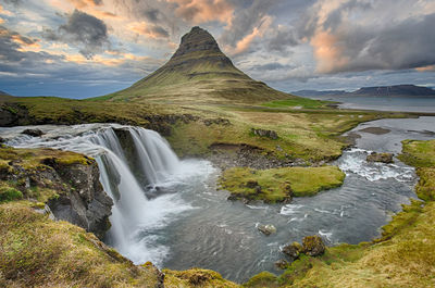Scenic view of lake against cloudy sky