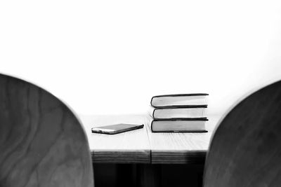 Close-up of empty seats on table against wall